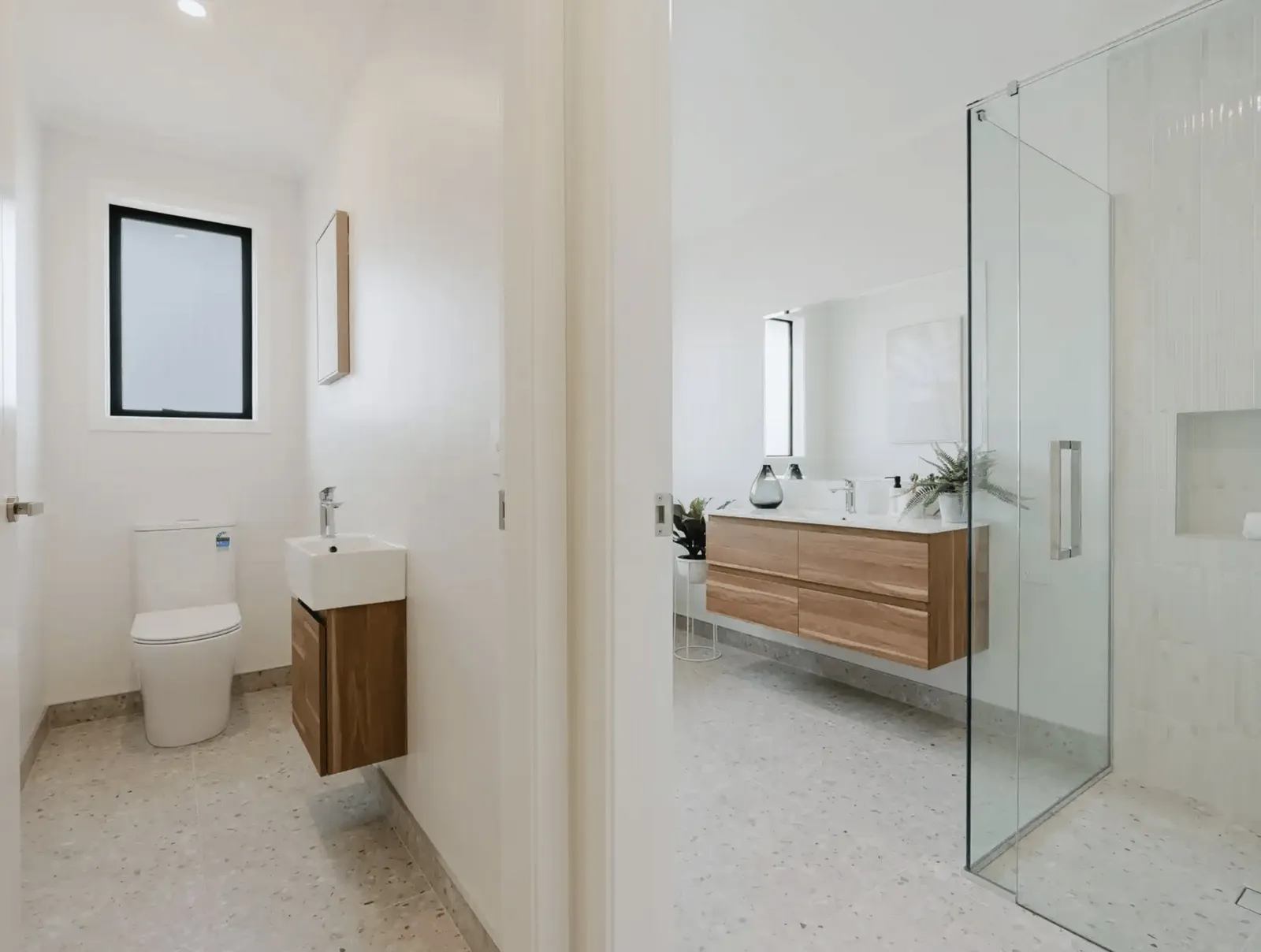 Image of modern neutral toilet and bathroom with timber cabinetry and pale grey tiling in Collinson Street, Pirongia new home, by Waikato residential builders Whitechurch Construction Limited.