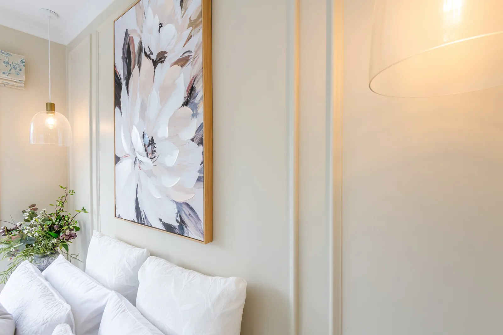 Image of newly renovated guest double bedroom in sand. Large floral print on the wall. Renovated by local Te Awamutu residential builders, Whitechurch Construction.
