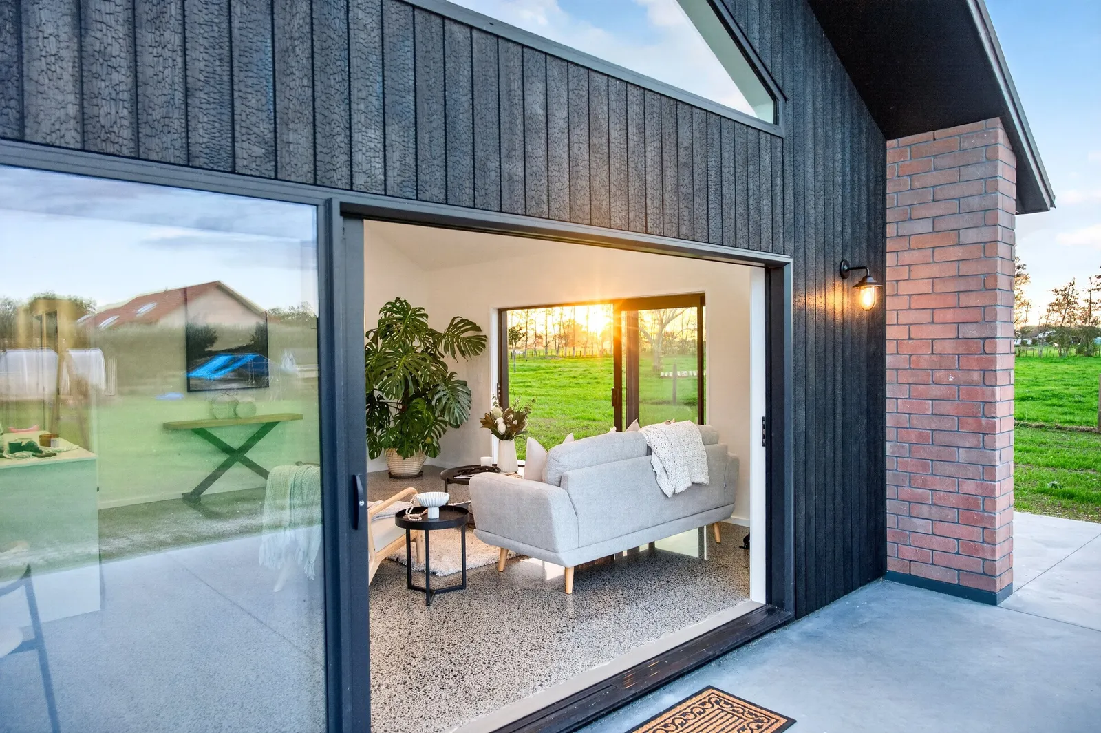 Red brick home with burnt Japanese cedar feature gable end by Whitechurch Construction, Te Awamutu builders.