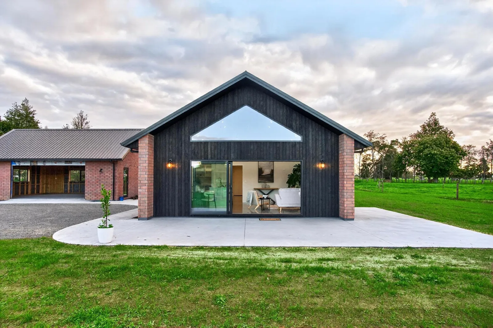Red brick home with burnt Japanese cedar feature gable end by Whitechurch Construction, Te Awamutu builders.