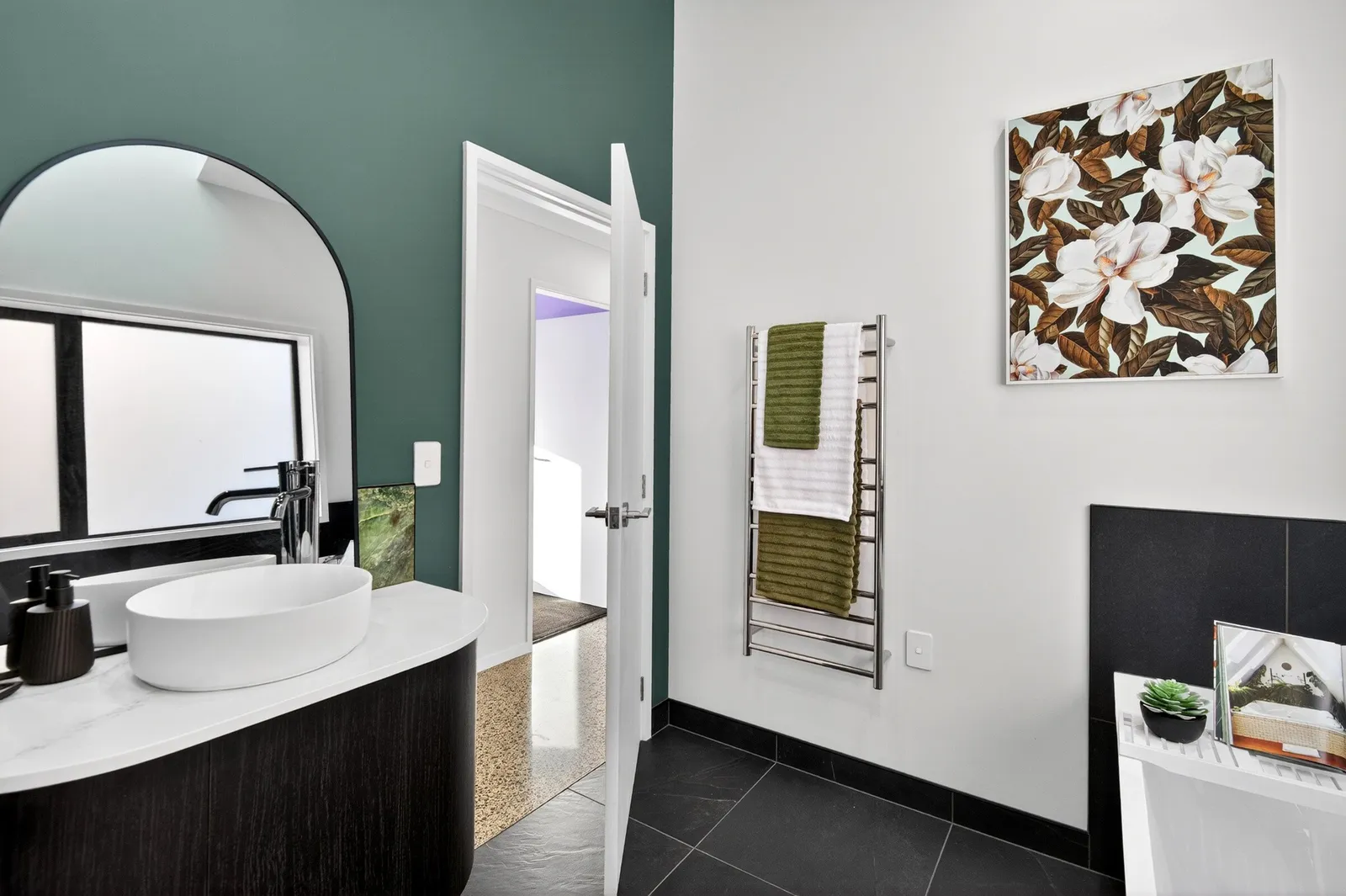 Modern earthy bathroom with forest green feature wall in Gordonton Road new build by Whitechurch Construction, Te Awamutu builders.