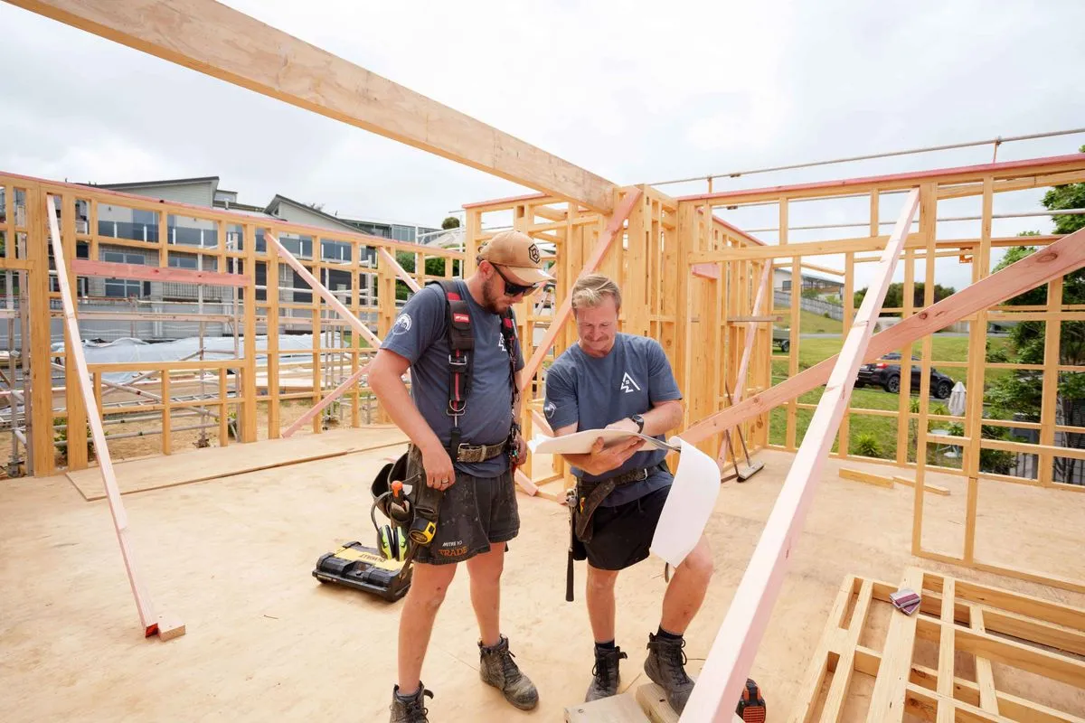 Builders reviewing plans on site.