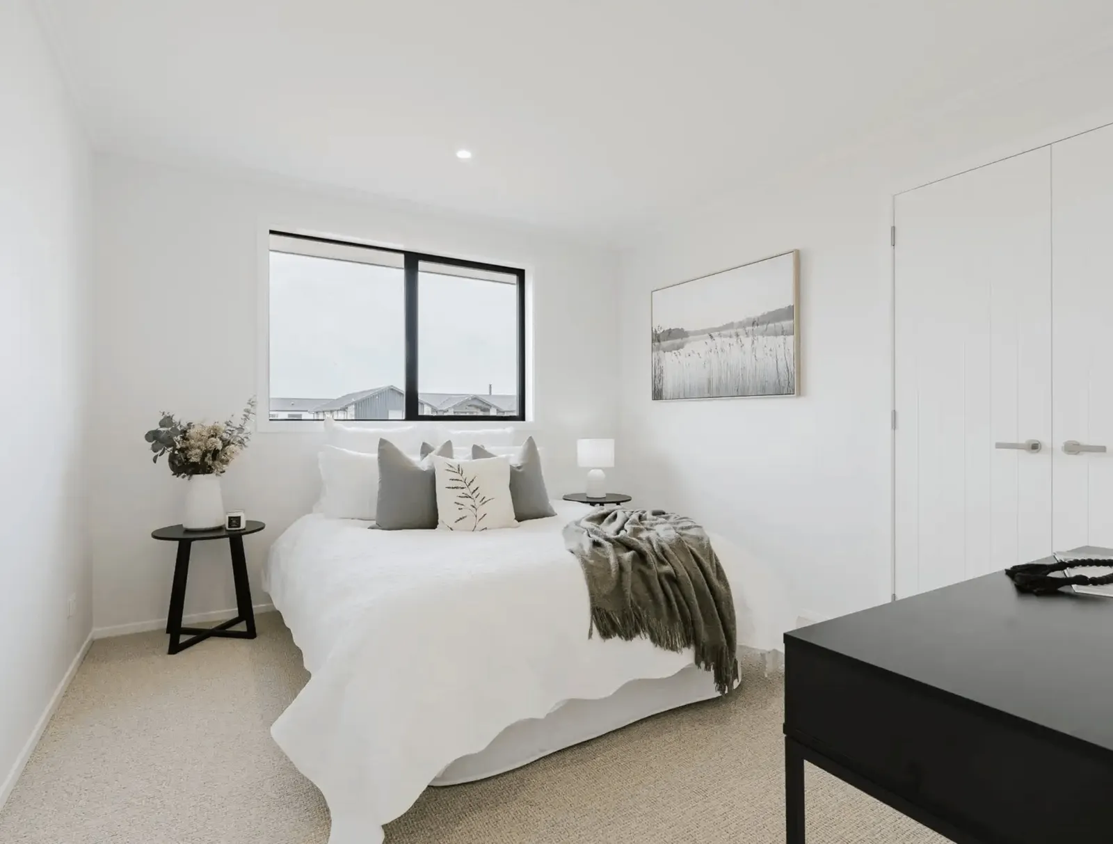 Image of natural light filled bedroom and soft grey styling in Collinson Street, Pirongia new home, by Waikato residential builders Whitechurch Construction Limited.