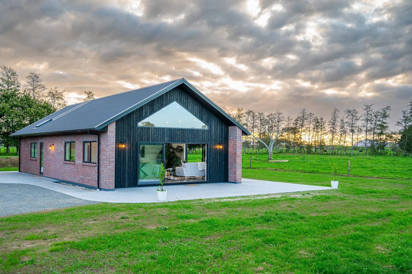 Red brick home with a burnt Japanese cedar feature gable, built by Whitechurch Construction