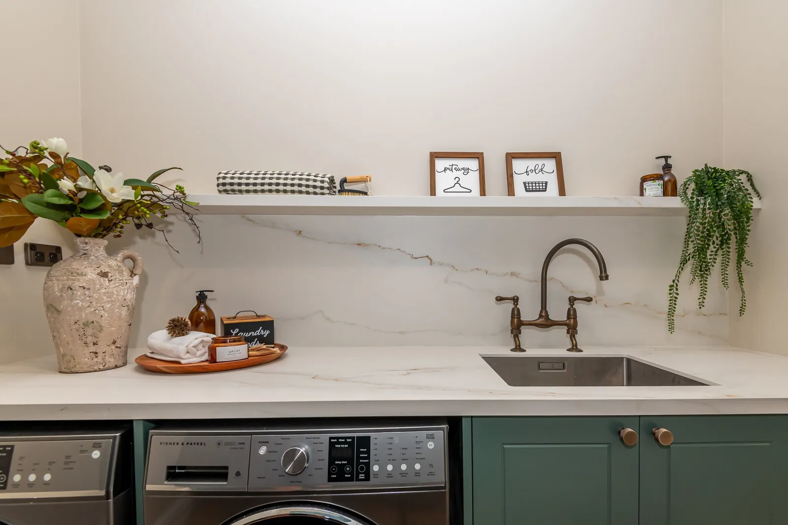 Image of newly renovated heritage laundry room in deep sage & white. Renovated by local Te Awamutu residential builders, Whitechurch Construction.