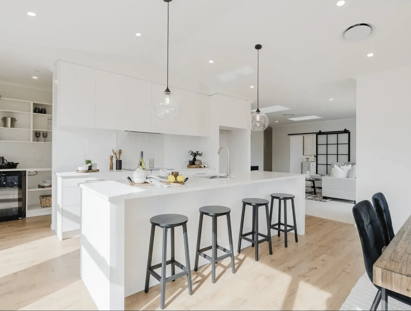 Image of light filled white washed modern kitchen with island bench in Collinson Street, Pirongia new home, by Waikato residential builders Whitechurch Construction Limited.